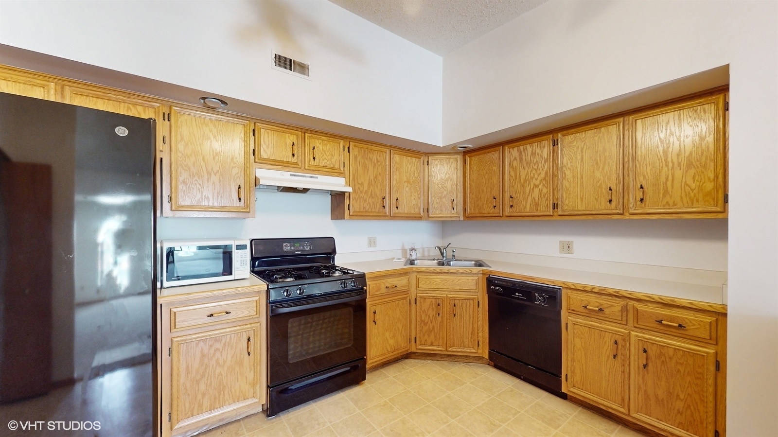 2851 West Heritage Drive, Unit 2C Joliet, IL 60435 - Photo 10 of 23 a kitchen with a sink cabinets stainless steel appliances and a window