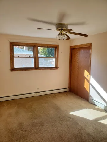 an empty room with windows and painted walls