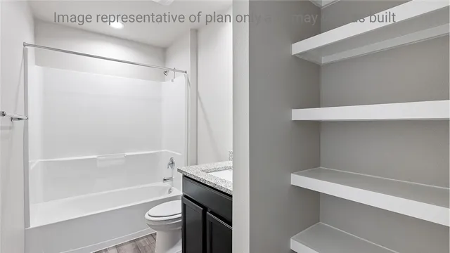 a bathroom with a shower a toilet and a sink