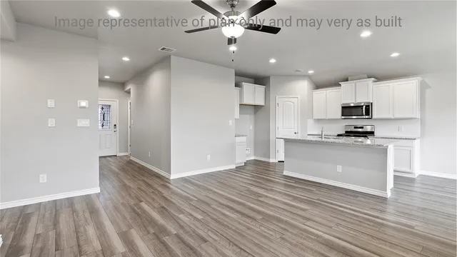 a view of kitchen with sink microwave and refrigerator