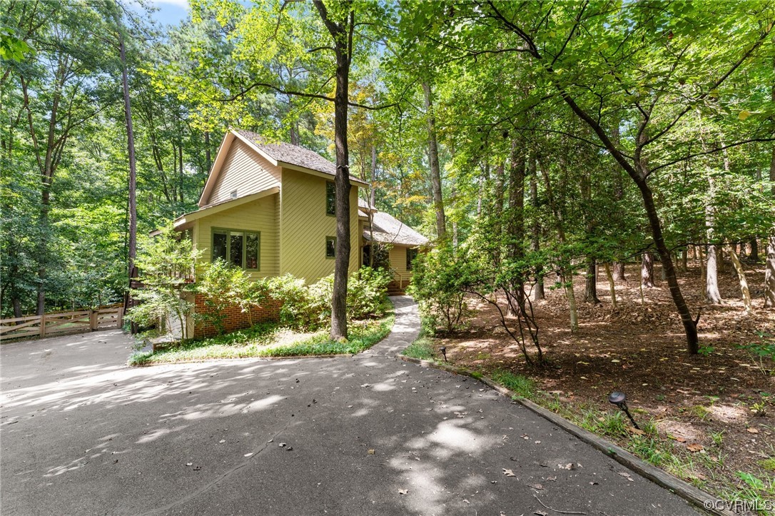 a front view of a house with a yard and tree s