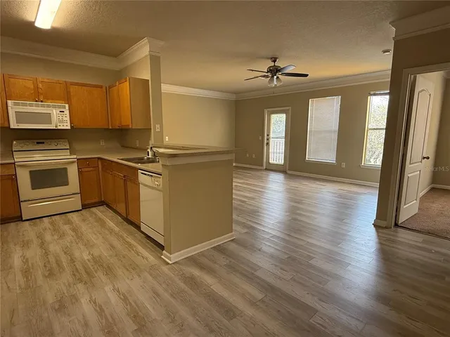 a kitchen with stainless steel appliances granite countertop a stove top oven and sink