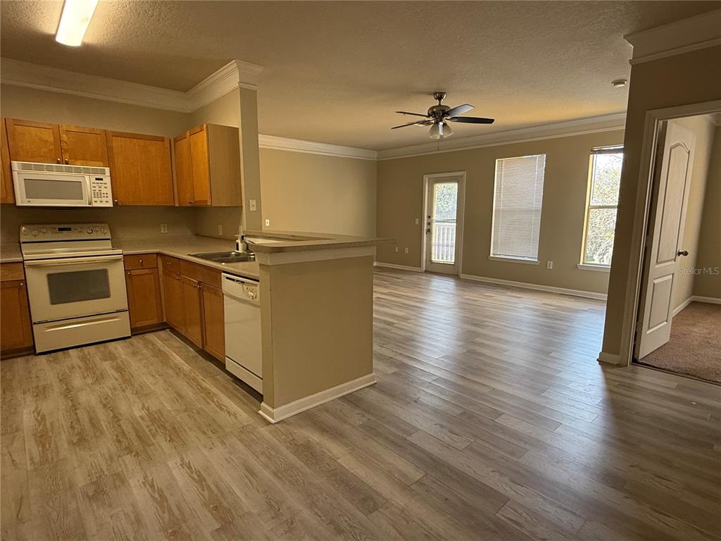 8848 Villa View Circle, Unit 206 Orlando, FL 32821 - Photo 6 of 20 a kitchen with stainless steel appliances granite countertop a stove top oven and sink