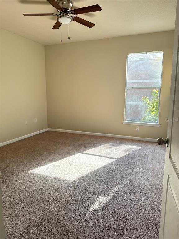 8848 Villa View Circle, Unit 206 Orlando, FL 32821 - Photo 9 of 20 an empty room with a window and a fan