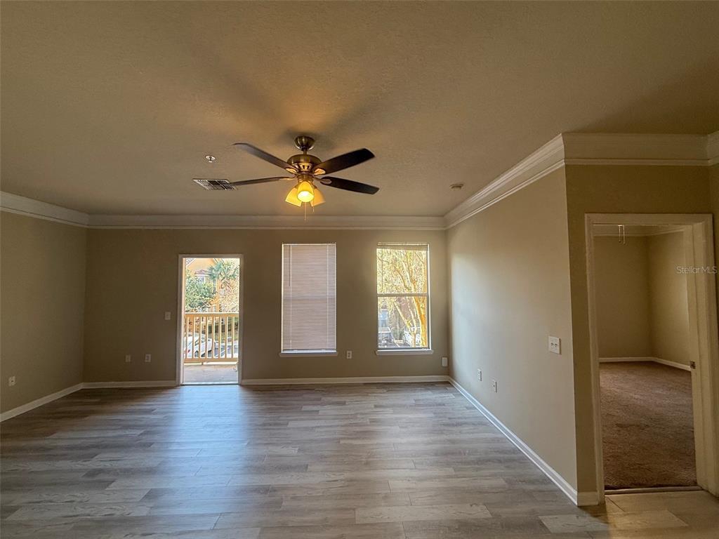 8848 Villa View Circle, Unit 206 Orlando, FL 32821 - Photo 10 of 20 a view of an empty room with window and wooden floor