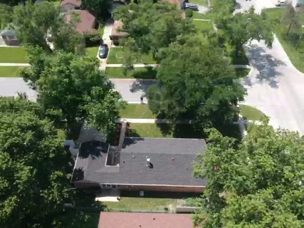 an aerial view of a house with a yard