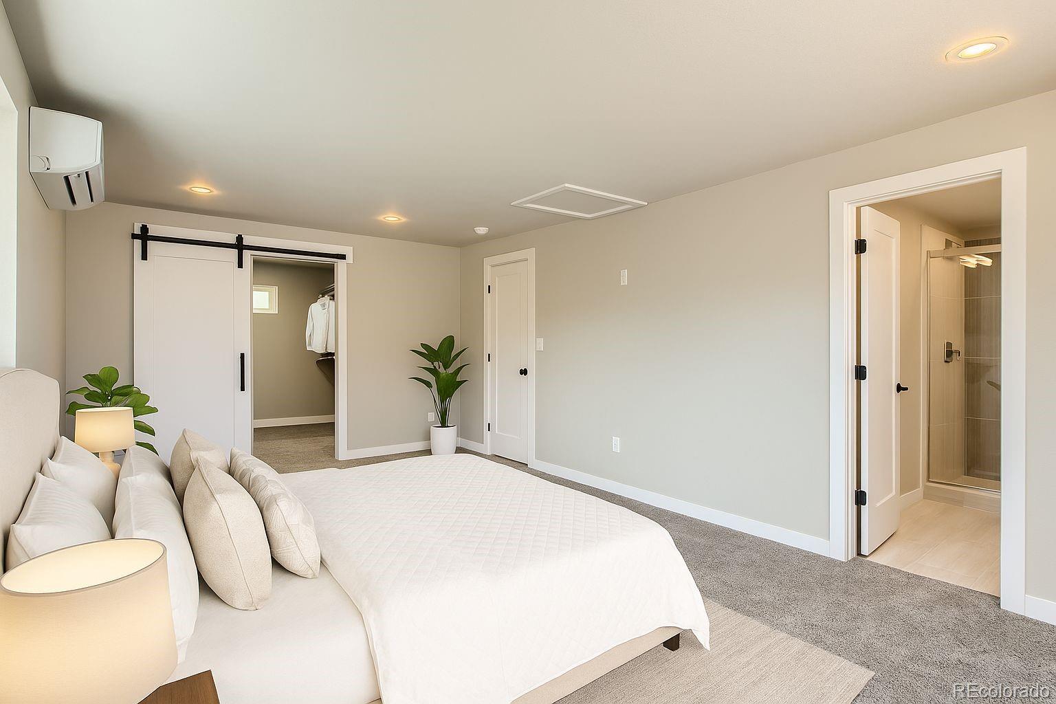 8530 West 46th Avenue Wheat Ridge, CO 80033 - Photo 11 of 20 a bedroom with a bed and a potted plant