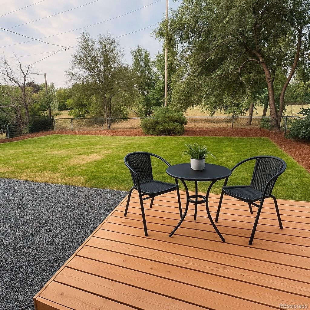 8530 West 46th Avenue Wheat Ridge, CO 80033 - Photo 9 of 20 a view of a lake with a table and chairs