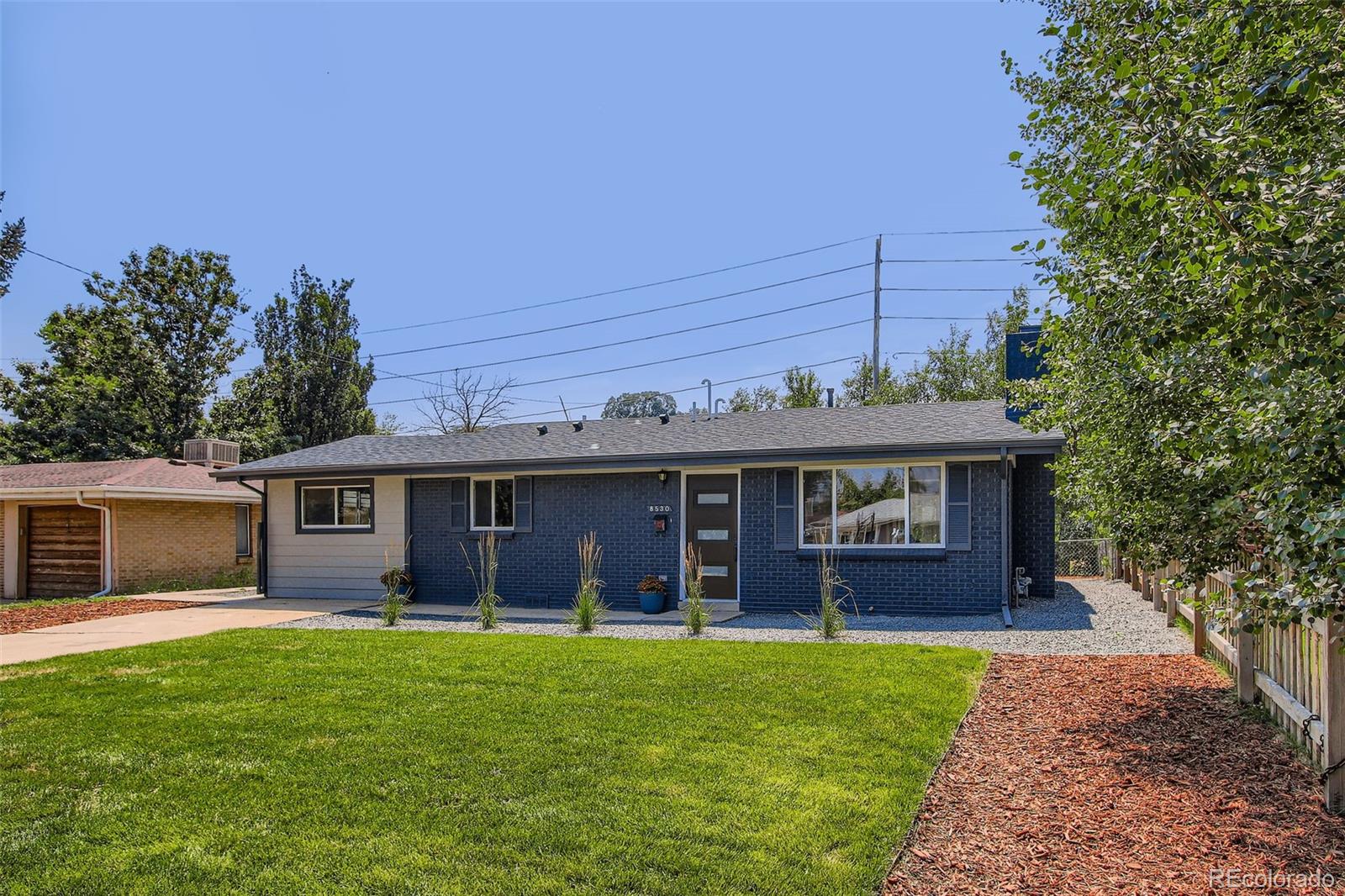 8530 West 46th Avenue Wheat Ridge, CO 80033 - Photo 10 of 20 a view of a house with backyard porch and garden