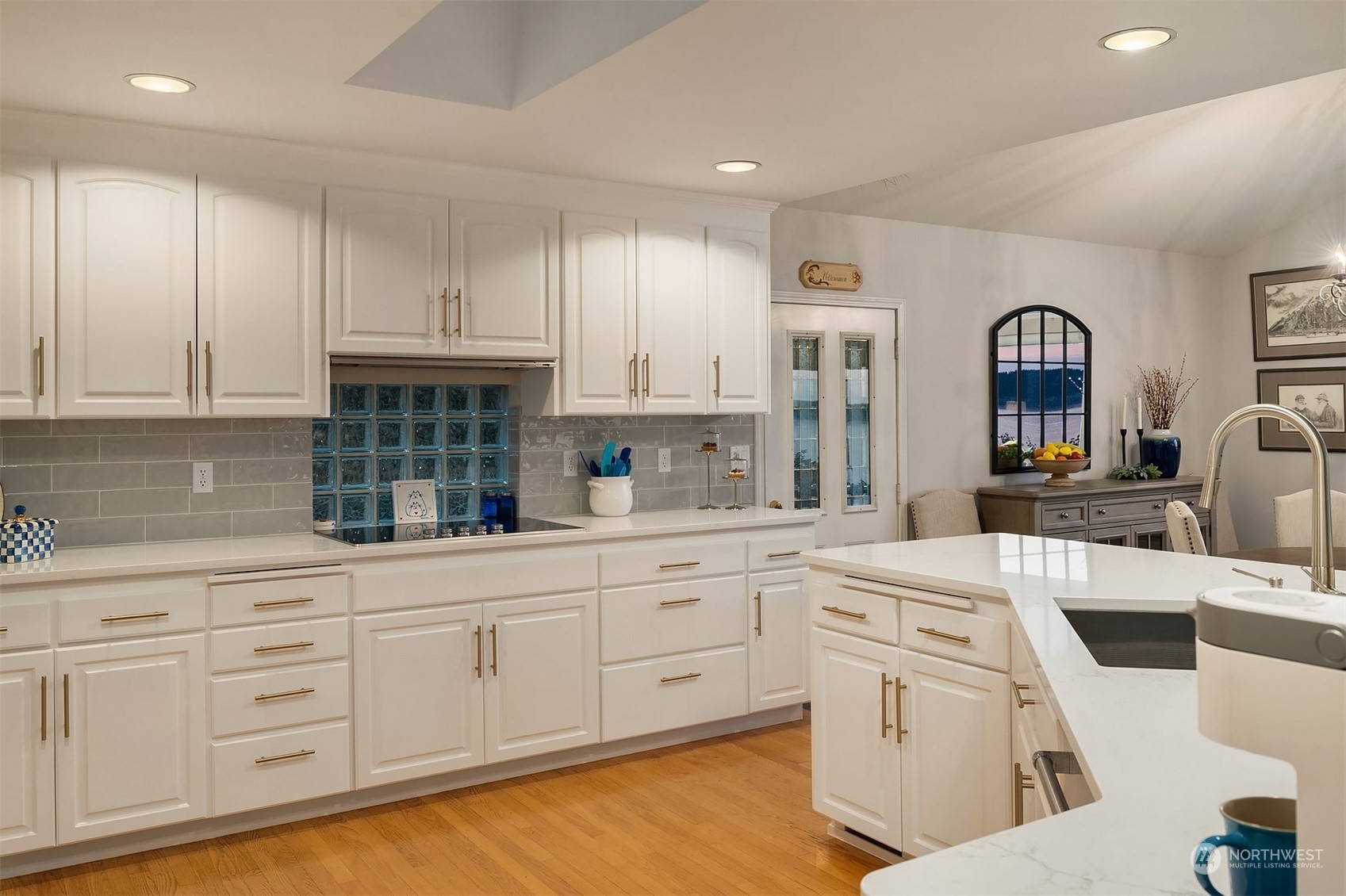 6831 Fisher Road Edmonds, WA 98026 - Photo 19 of 35 a kitchen with white cabinets and sink