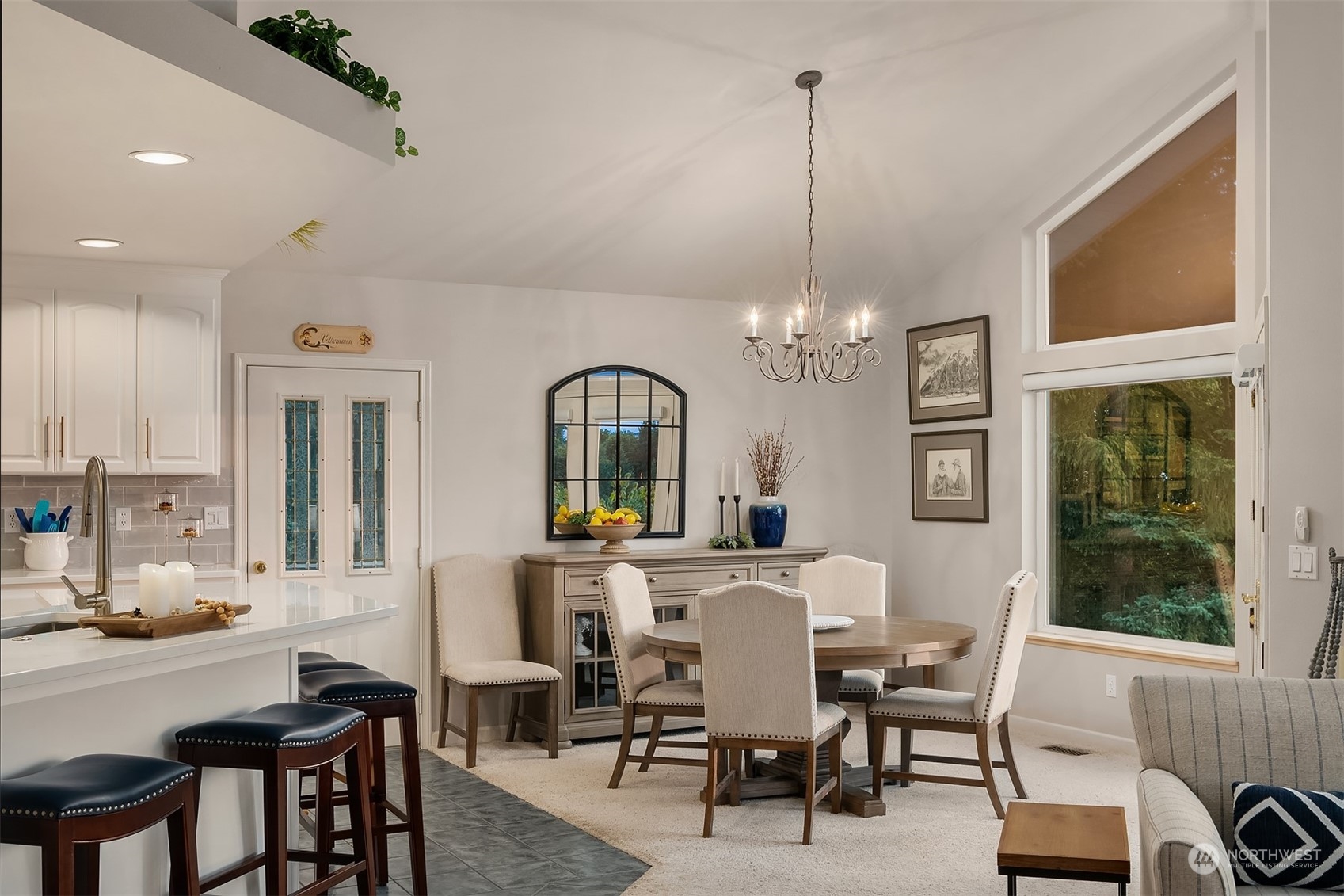 6831 Fisher Road Edmonds, WA 98026 - Photo 23 of 35 a view of a dining room with furniture a chandelier and window