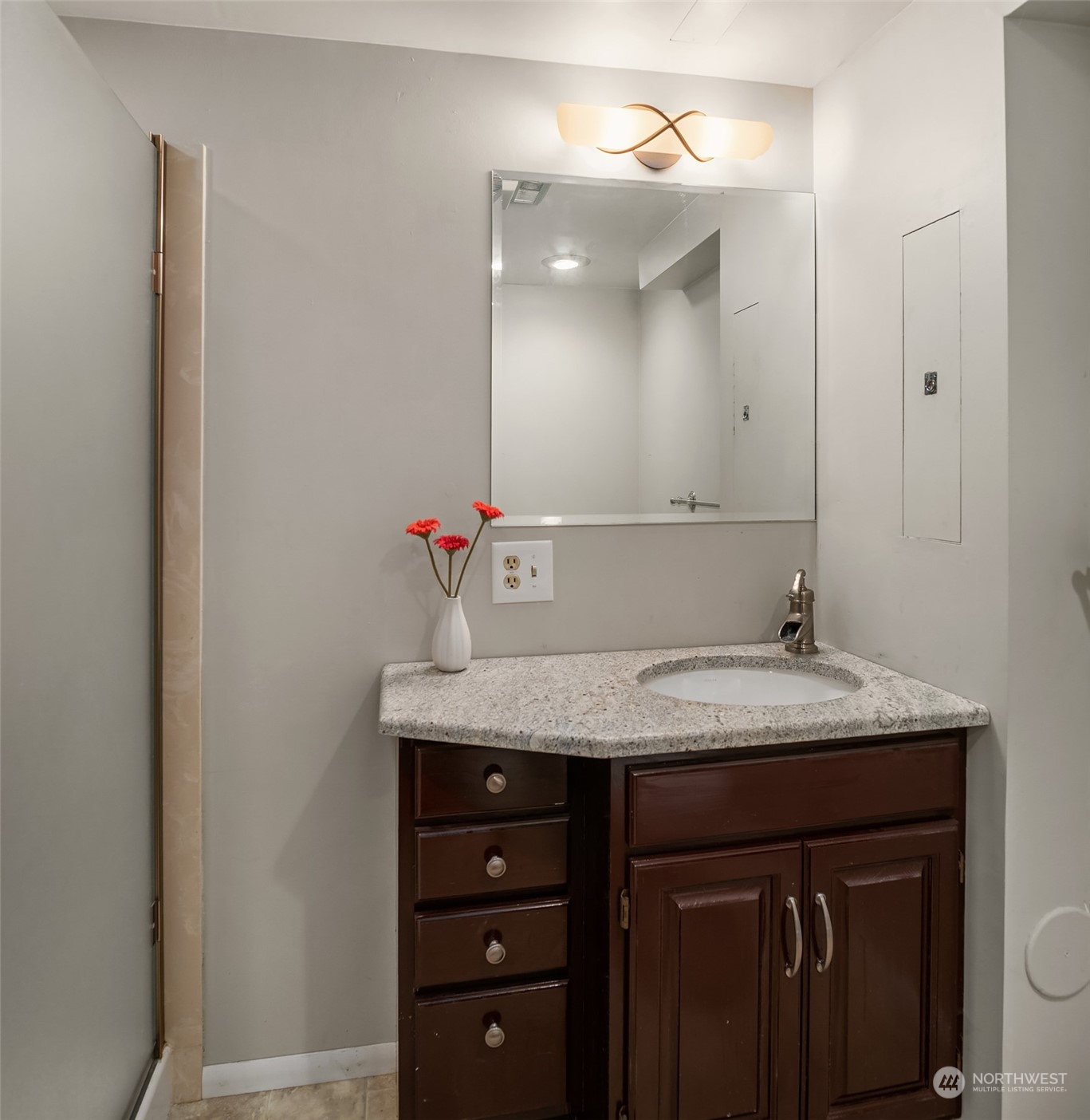 6831 Fisher Road Edmonds, WA 98026 - Photo 29 of 35 a bathroom with a granite countertop sink and a mirror