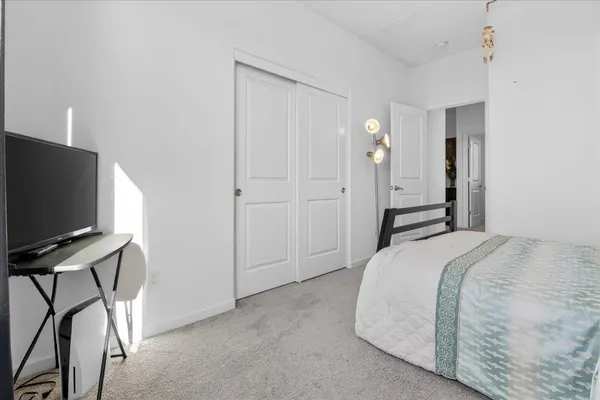 a bedroom with bed and a window