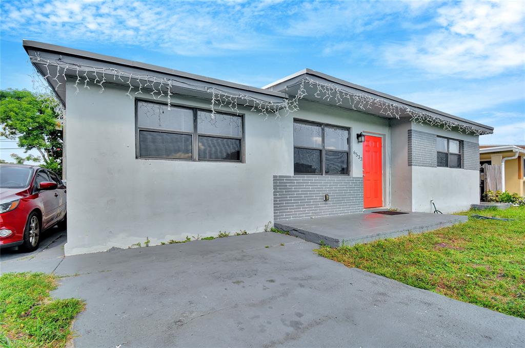 6533 Southwest 22nd Street Miramar, FL 33023 - Photo 1 of 16 a front view of a house with a yard and garage
