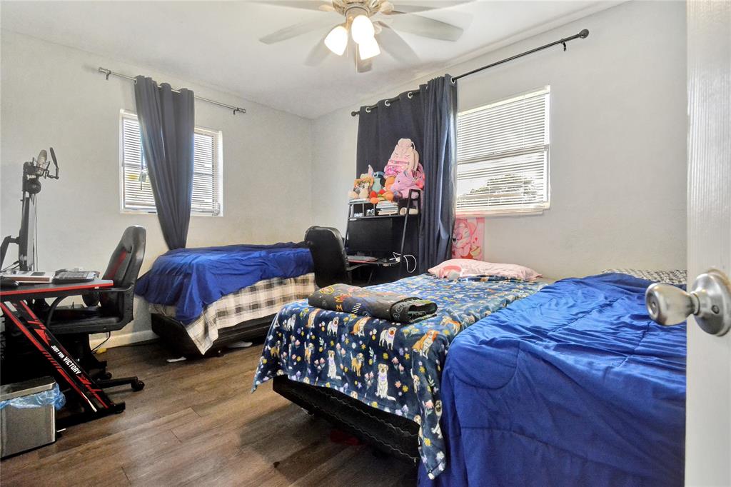 6533 Southwest 22nd Street Miramar, FL 33023 - Photo 12 of 16 a bedroom with a bed and wooden floor