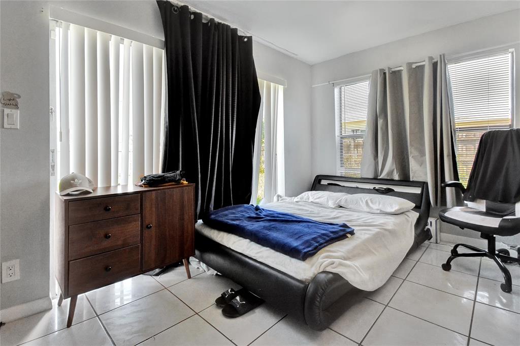 6533 Southwest 22nd Street Miramar, FL 33023 - Photo 4 of 16 a spacious bedroom with a bed and a window