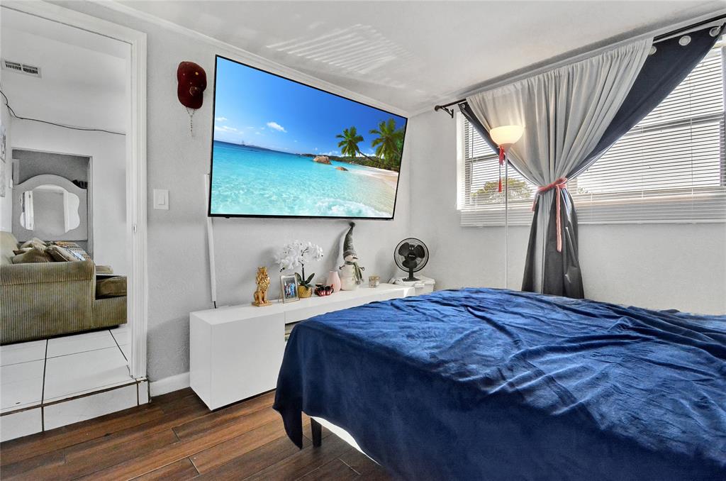 6533 Southwest 22nd Street Miramar, FL 33023 - Photo 10 of 16 a bedroom with a bed and a dresser