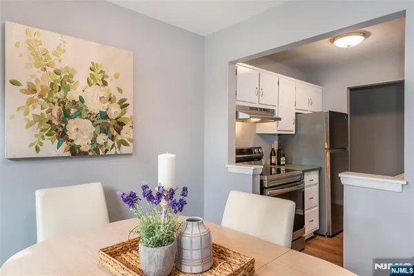 a kitchen with stainless steel appliances granite countertop a refrigerator and a stove