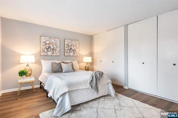 a bedroom with a bed and a painting on the wall