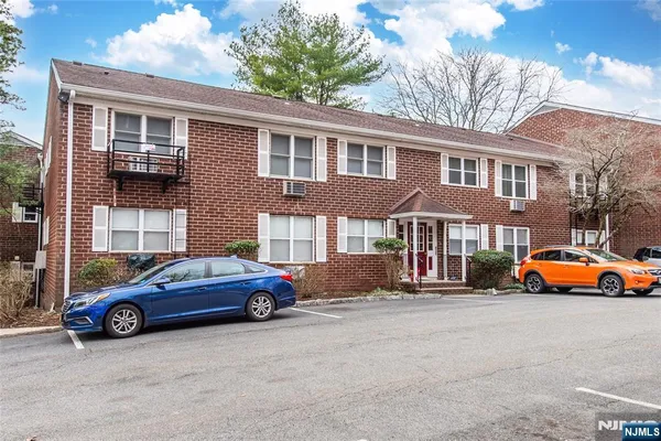 a front view of a house with parking space