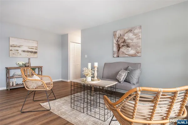 a living room with a couch and a painting on the wall