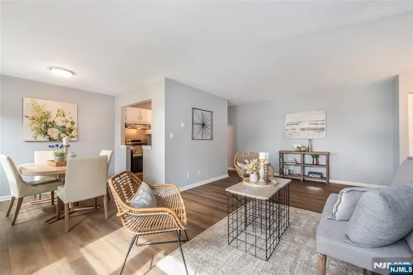 a living room with furniture and a dining table with chair
