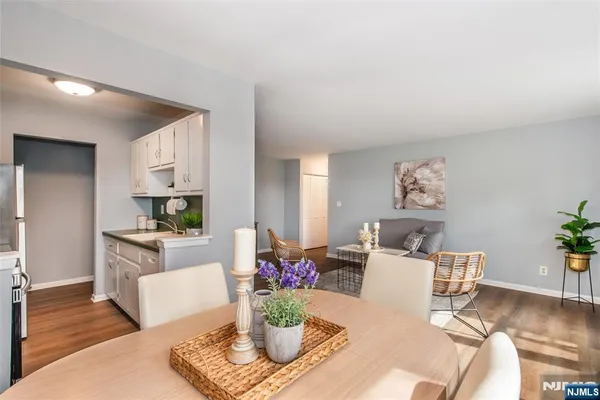 a living room with furniture and a dining table