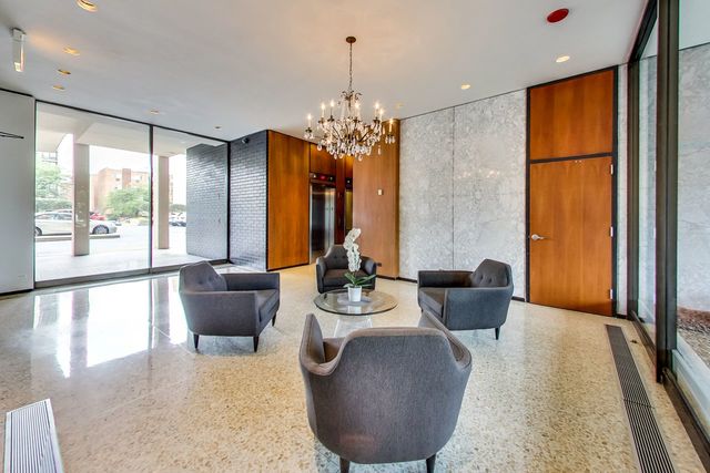 5733 North Sheridan Road, Unit 16B Chicago, IL 60660 - Photo 2 of 27 a dining room with furniture a chandelier and wooden floor