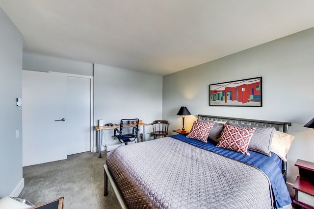 5733 North Sheridan Road, Unit 16B Chicago, IL 60660 - Photo 18 of 27 a bed sitting in a bedroom and table