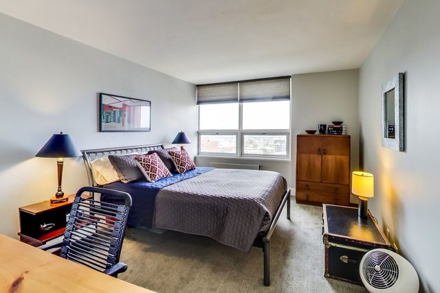 5733 North Sheridan Road, Unit 16B Chicago, IL 60660 - Photo 19 of 27 a bedroom with a bed and wooden floor