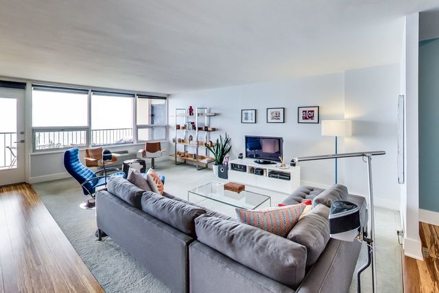 5733 North Sheridan Road, Unit 16B Chicago, IL 60660 - Photo 6 of 27 a living room with furniture and a flat screen tv
