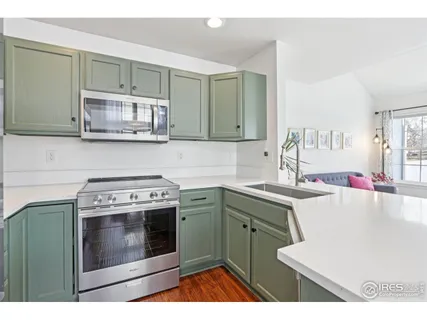 a kitchen with a stove sink and cabinets
