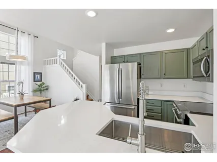 a kitchen with stainless steel appliances a refrigerator and a stove top oven