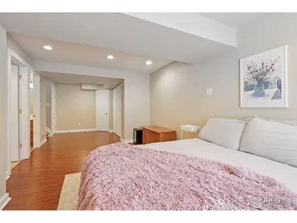 a bedroom with a large bed and a painting