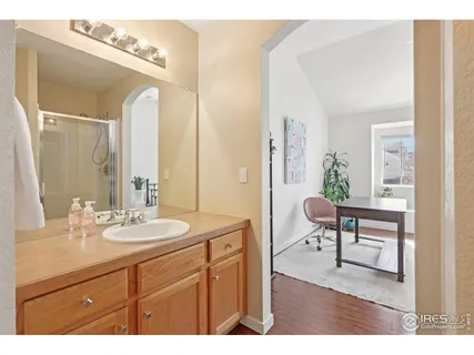 a bathroom with a sink vanity granite and a mirror