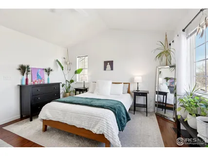 a bedroom with a bed and a potted plant