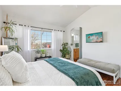 a bedroom with a large bed and a window