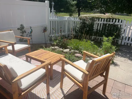 a view of backyard with outdoor seating and plants