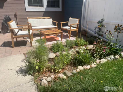 a backyard of a house with table and chairs
