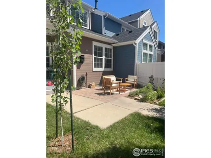 a view of a house with backyard sitting area and porch