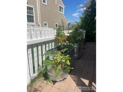 a view of a balcony with chair and potted plants