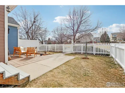 a view of a yard with wooden fence