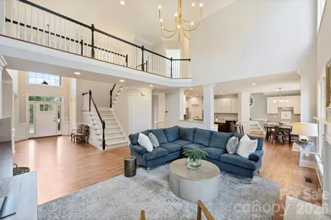 a living room with furniture a table and wooden floor