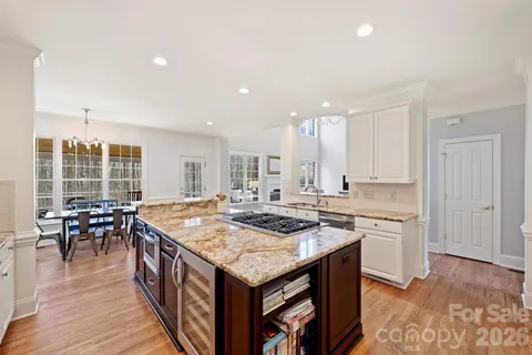 a kitchen with a stove a table and chairs in it