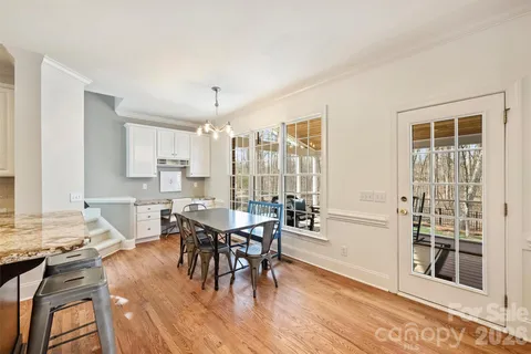 a view of a a dining room with furniture window and wooden floor