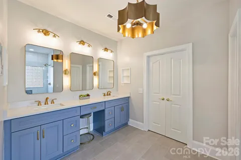 a spacious bathroom with a double vanity sink and a mirror