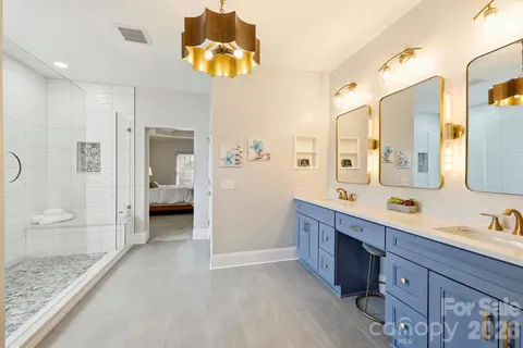 a spacious bathroom with a granite countertop sink mirror and shower