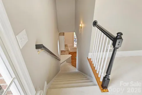 a view of staircase with railing and stairs