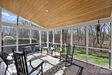 a balcony with chairs and with wooden floor