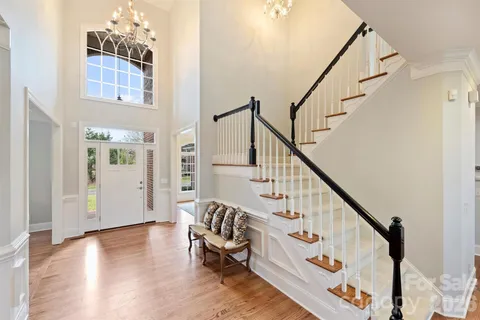a view of entryway with hardwood and stairs